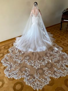 a woman in a wedding dress is standing on the floor next to a grand piano