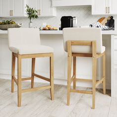 two stools sitting in front of a kitchen counter