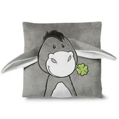 a gray and white pillow with a cartoon animal on it's face holding a leaf