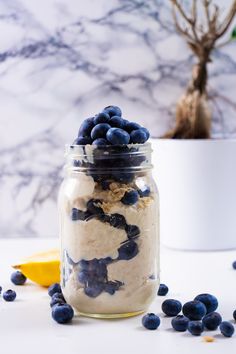 a jar filled with blueberries and oatmeal on top of a table