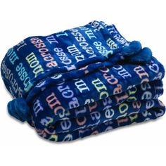 the blue blanket has multicolored letters on it and is rolled up in three rows