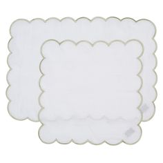 two white place mats with scalloped edges