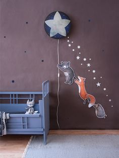 a child's room with a blue crib and stars on the wall