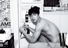 a shirtless young man sitting in front of an open refrigerator