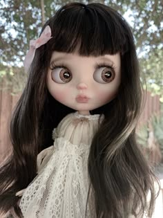 a close up of a doll with long hair