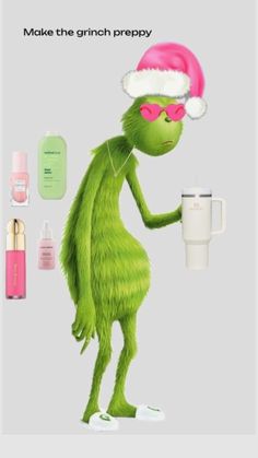 the grinch is holding a cup and wearing a santa hat