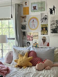 a bed with pillows and stuffed animals on it