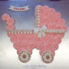 a pink baby carriage made out of cupcakes