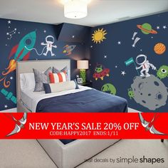 a bed room with a neatly made bed and space themed wallpaper