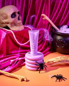 a fake skull sitting on top of a table next to a tube of lotion