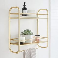 a bathroom shelf with two shelves and towels on it