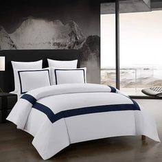 a white and blue bed in a room