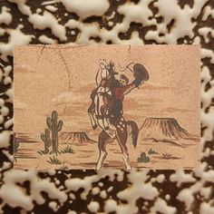 an image of a desert scene with a cowboy on a horse and cactus in the background