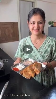 a woman holding a tray of food in her hands