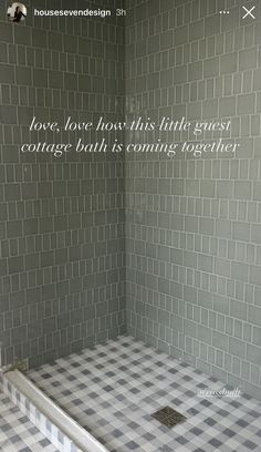 a bathroom with grey and white tiles on the walls, flooring and shower stall