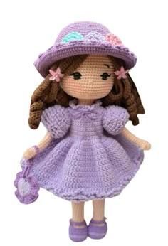 a crocheted doll wearing a purple dress and hat