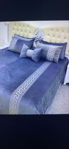 a bed with blue sheets and pillows on it