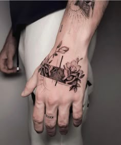 a person's hand with a tattoo on it