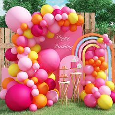 an outdoor birthday party with balloons and streamers on the wall, tables and chairs