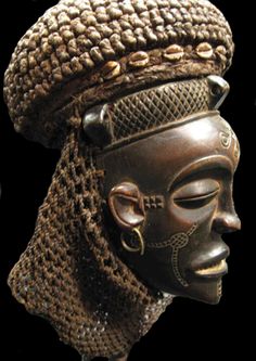 an african mask is displayed on a black background