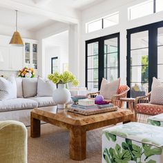 a living room filled with furniture and lots of windows