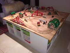 a toy train set sitting on top of a wooden table