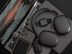 an assortment of electronic devices sitting on top of a table next to a laptop computer