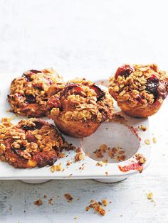 muffins with crumbled topping on a white tray