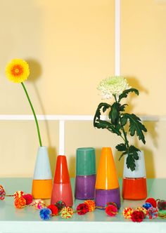 colorful vases and flowers on a table