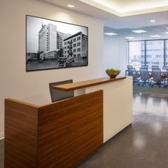 an office with a desk, chairs and pictures on the wall