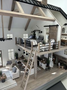 a model of a living room and bedroom with stairs to the second floor that lead up to an upper level loft