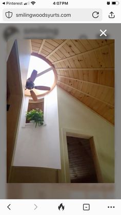 the ceiling fan is on top of the window in the room that looks like it's made out of wood