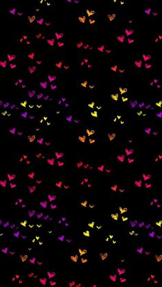 many different colored hearts on a black background