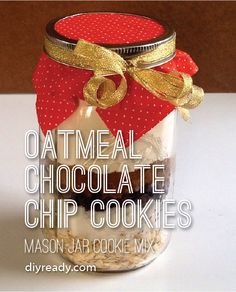 a mason jar filled with oatmeal chocolate chip cookies and topped with a red bow