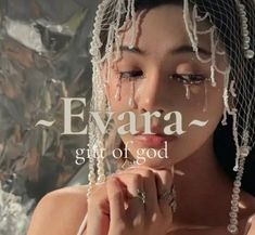 a woman wearing a veil and holding her hands to her face with the words evara on