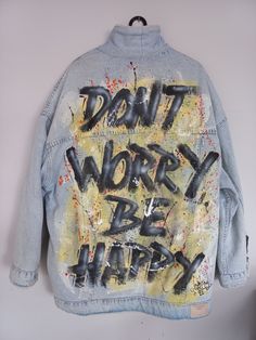 a jean jacket with the words dirty work be happy painted on it