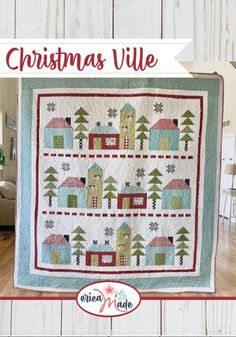 the christmas village quilt pattern is displayed on a wooden wall with text overlaying it