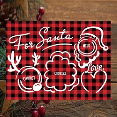 a red and black checkered christmas card with the words for santa milk, carrots, and pine cones