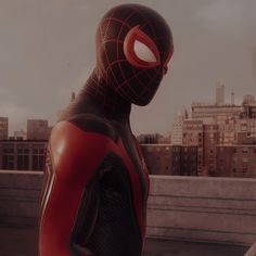 a spider - man standing in front of a city skyline