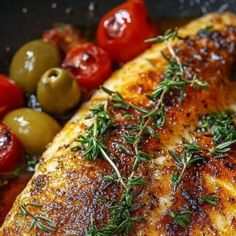 chicken with herbs and olives in a pan