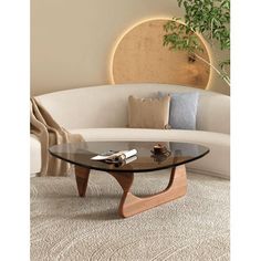 This coffee table draws inspiration from the iconic 1950s design crafted by the renowned poet and sculptor, Isamu. The classic smooth curves are a testament to Isamu's defiance of conventional straight lines, embodying a sense of artistic rebellion. Our reproduction captures the essence of elegance and simplicity that this coffee table is celebrated for, making it a fitting addition to any contemporary home or workspace. Wrought Studio™ Table Base Color: Walnut | Wrought Studio™ Holderman Glass Nyc Dream, Triangle Coffee Table, Modern Wood Coffee Table, Living Room Center, Tafel Decor, Mid Century Modern Coffee Table, Glass End Tables, Mid Century Coffee Table, Table For Small Space