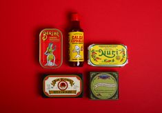 several tins and containers on a red surface