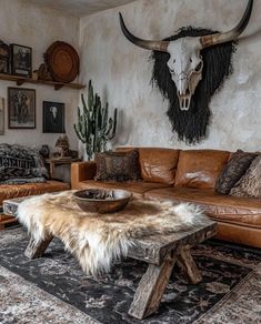 a living room filled with furniture and a cow skull on the wall