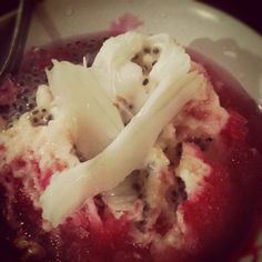 a close up of a bowl of food on a plate with a utensil