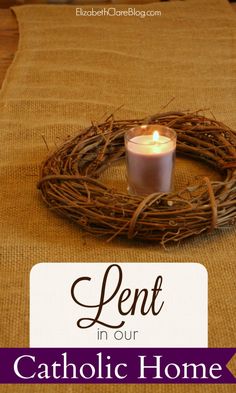 a candle sitting on top of a table with the words lent in our catholic home