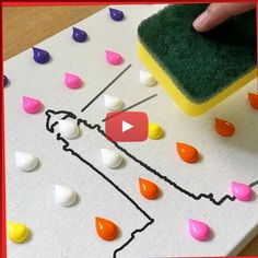 someone is using a sponge to paint the outline of a map with candy drops on it