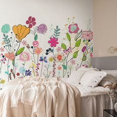 a bedroom with flowers painted on the wall