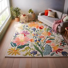 a living room filled with furniture and flowers on the rug