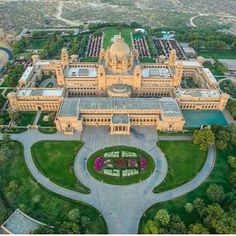 an aerial view of a large building in the middle of a park