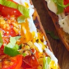 two slices of bread with tomatoes, cheese and basil on them next to a knife